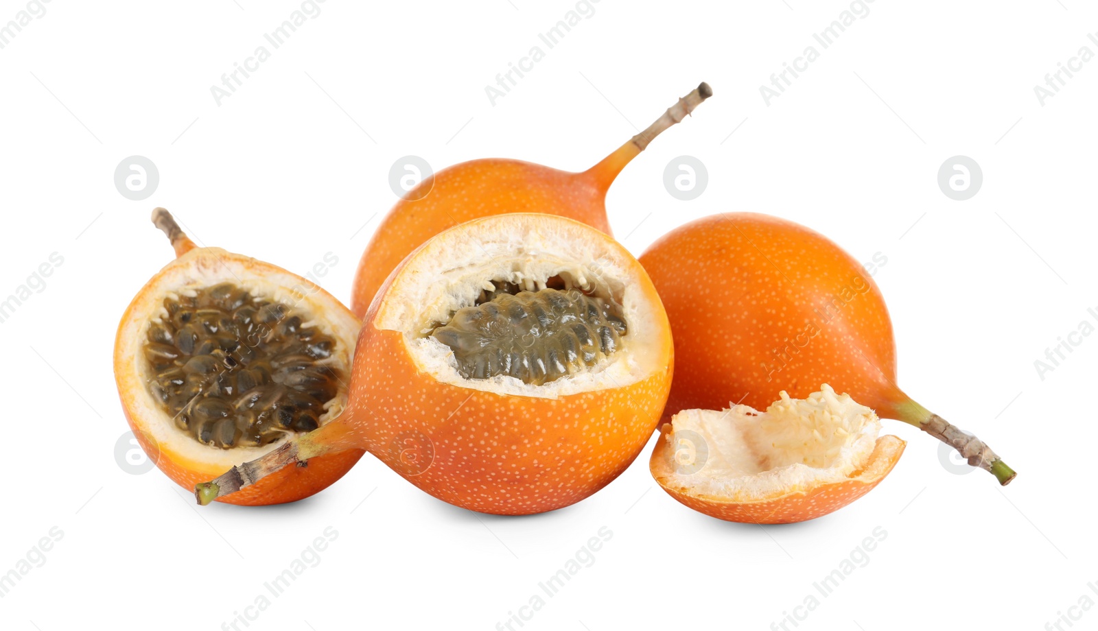 Photo of Whole and cut delicious granadillas on white background