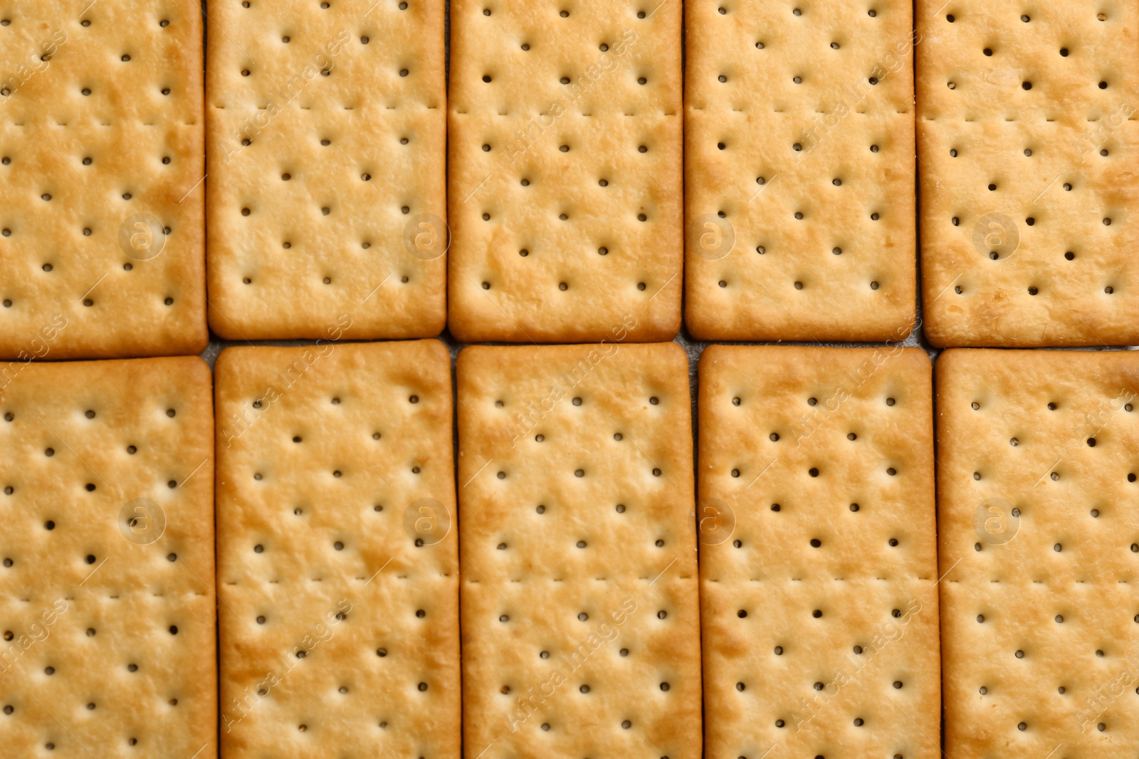 Photo of Many delicious crackers as background, top view