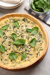 Photo of Delicious homemade spinach pie on light grey table, above view