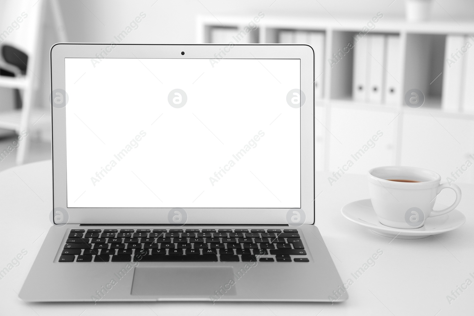 Photo of Comfortable workplace with modern laptop on table in office. Mockup for design