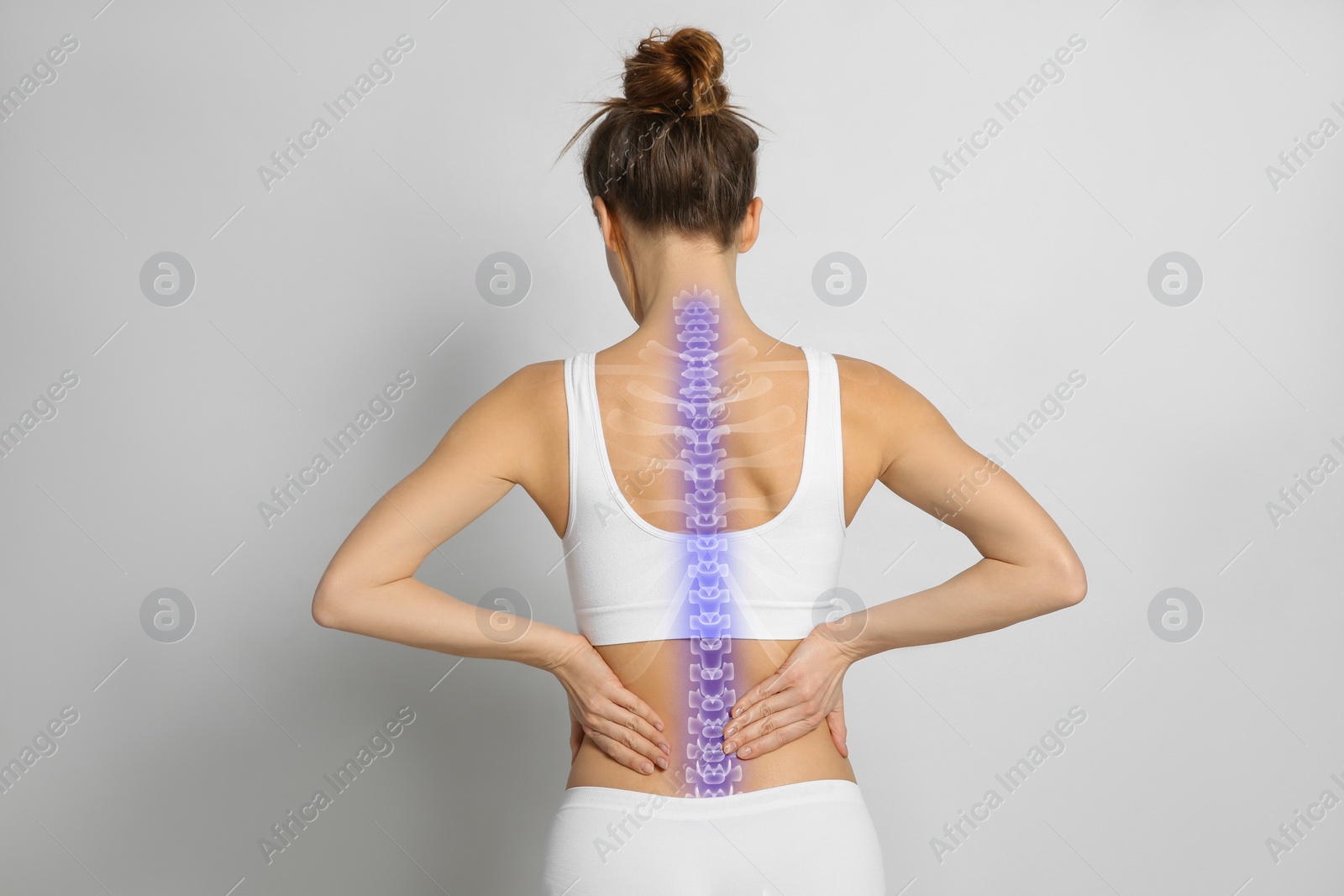 Image of Woman with healthy spine on light background, back view