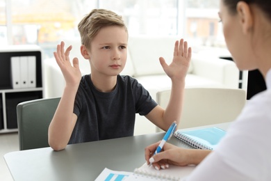 Photo of Little boy having appointment at child psychologist office