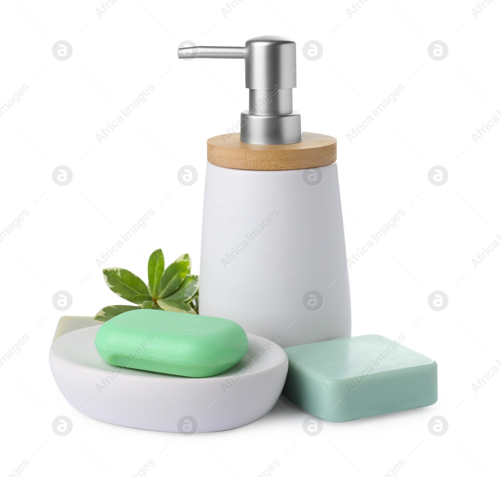 Photo of Soap bars and dispenser on white background