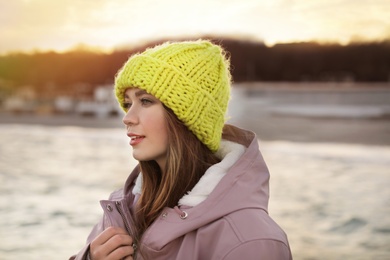 Portrait of stylish young woman near sea