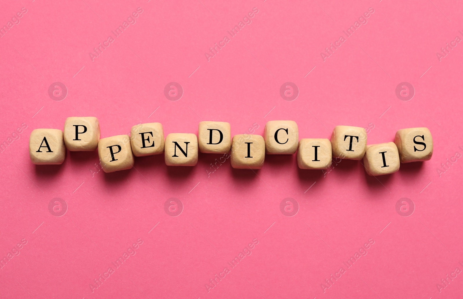 Photo of Word Appendicitis made of wooden cubes with letters on pink background, top view