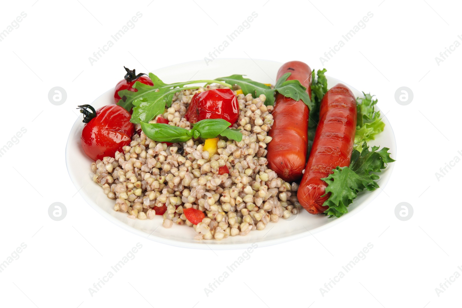 Photo of Tasty buckwheat porridge with sausages and vegetables isolated on white