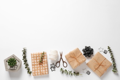 Photo of Composition of scissors and gifts on white background, top view