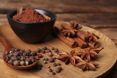 Photo of Aromatic anise stars and spices on wooden table