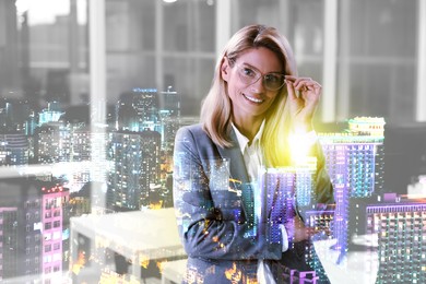 Double exposure of successful businesswoman and cityscape