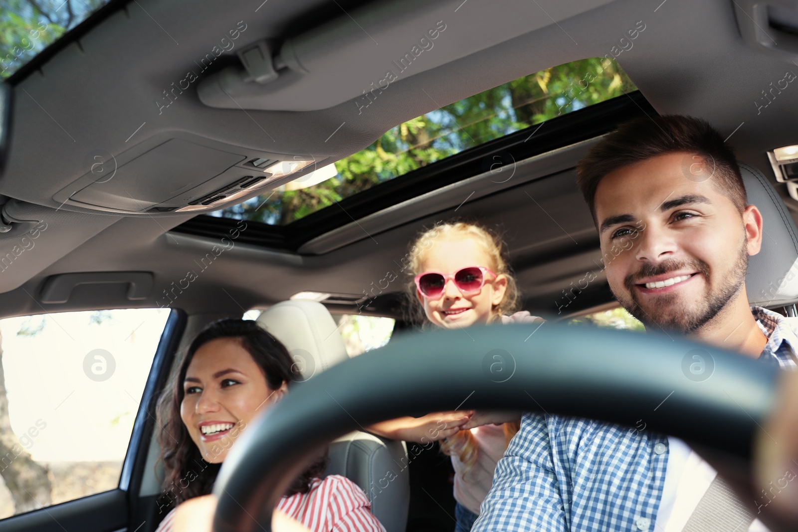 Photo of Happy family in car on road trip