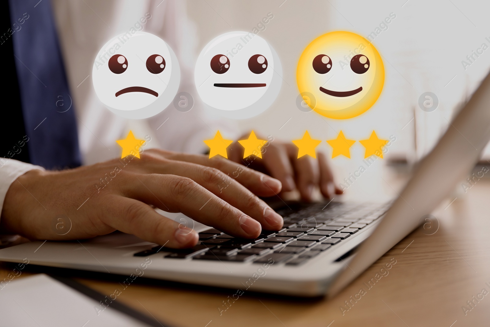 Image of Man using laptop to give feedback at wooden table, closeup