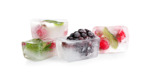 Photo of Ice cubes with berries and mint on white background