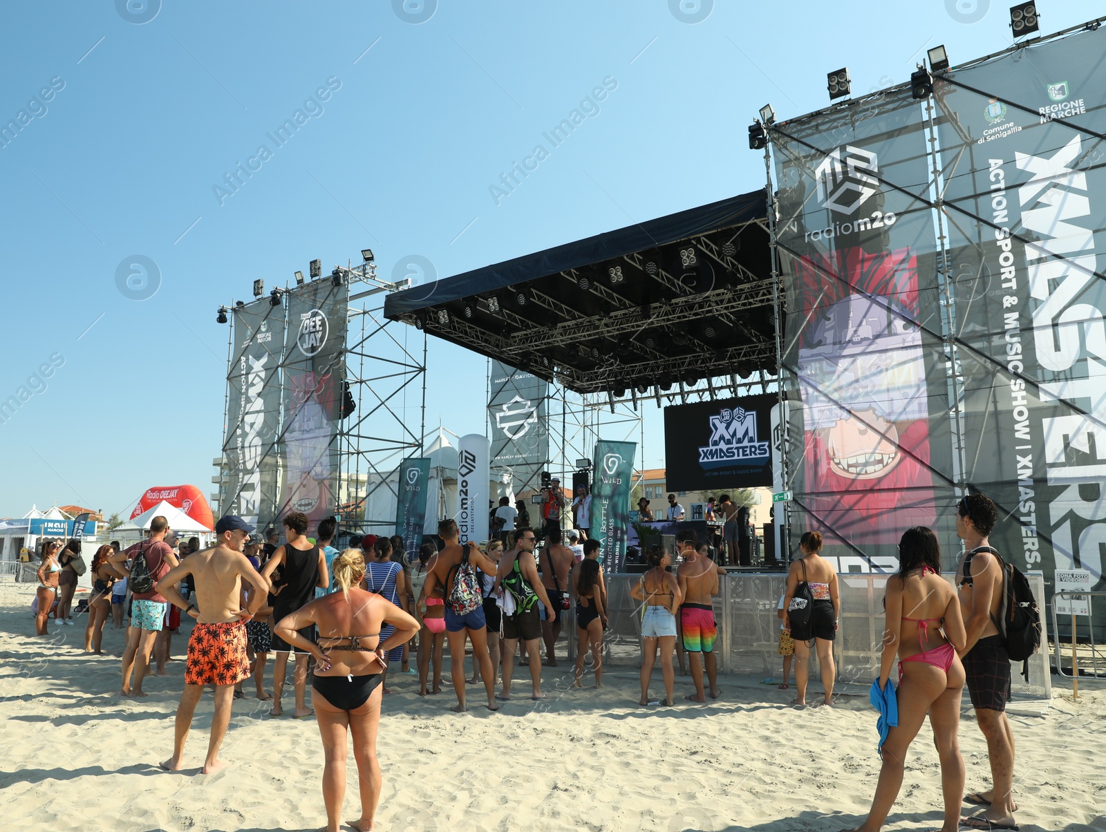 Photo of SENIGALLIA, ITALY - JULY 22, 2022: People enjoying music festival on beach
