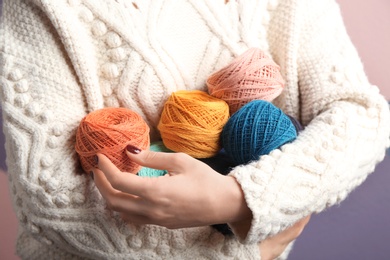 Photo of Woman holding clews of knitting threads, closeup