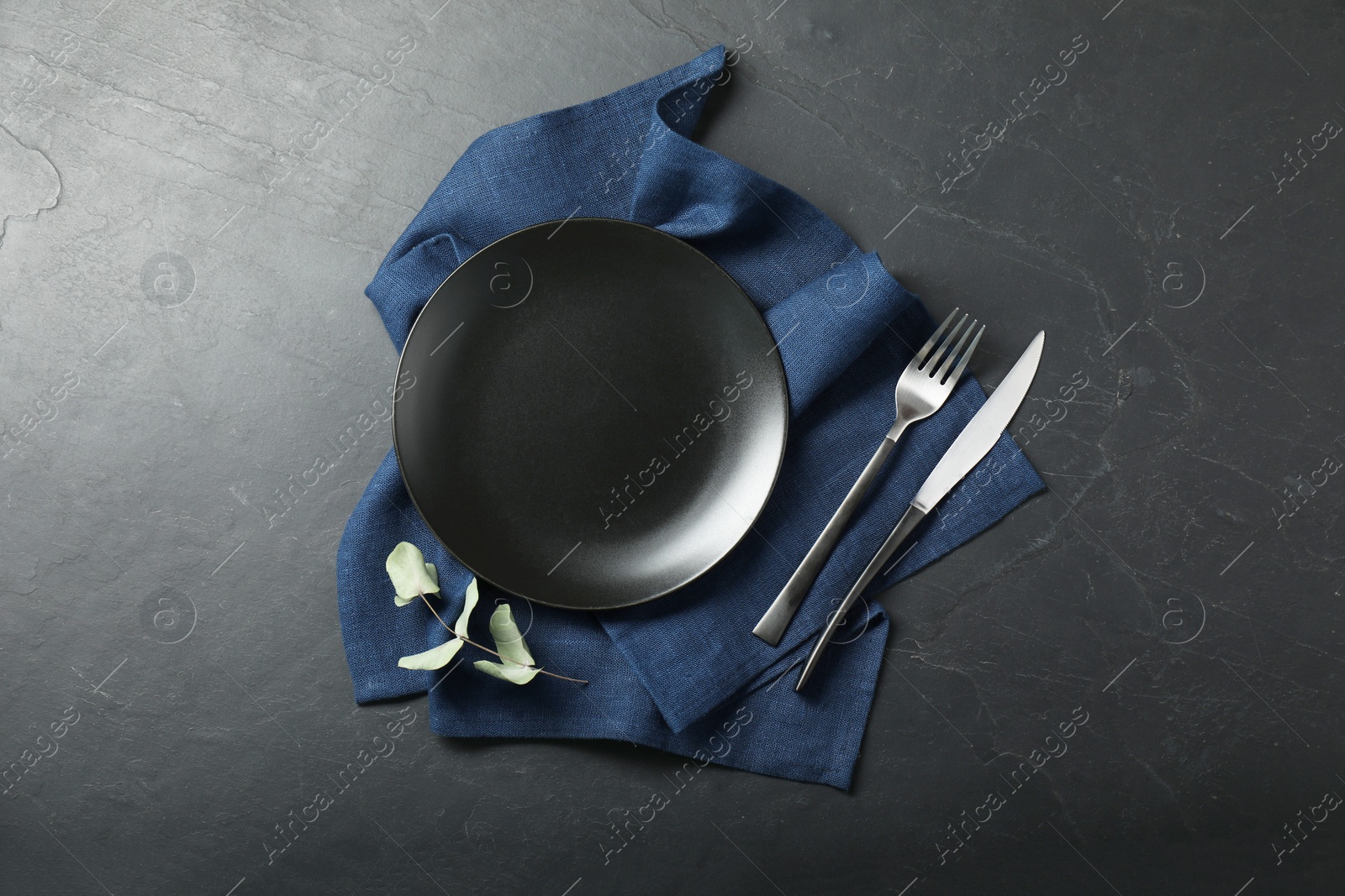 Photo of Stylish setting with elegant cutlery on grey textured table, top view