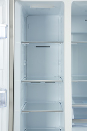 Photo of Shelves of empty modern refrigerator, closeup view