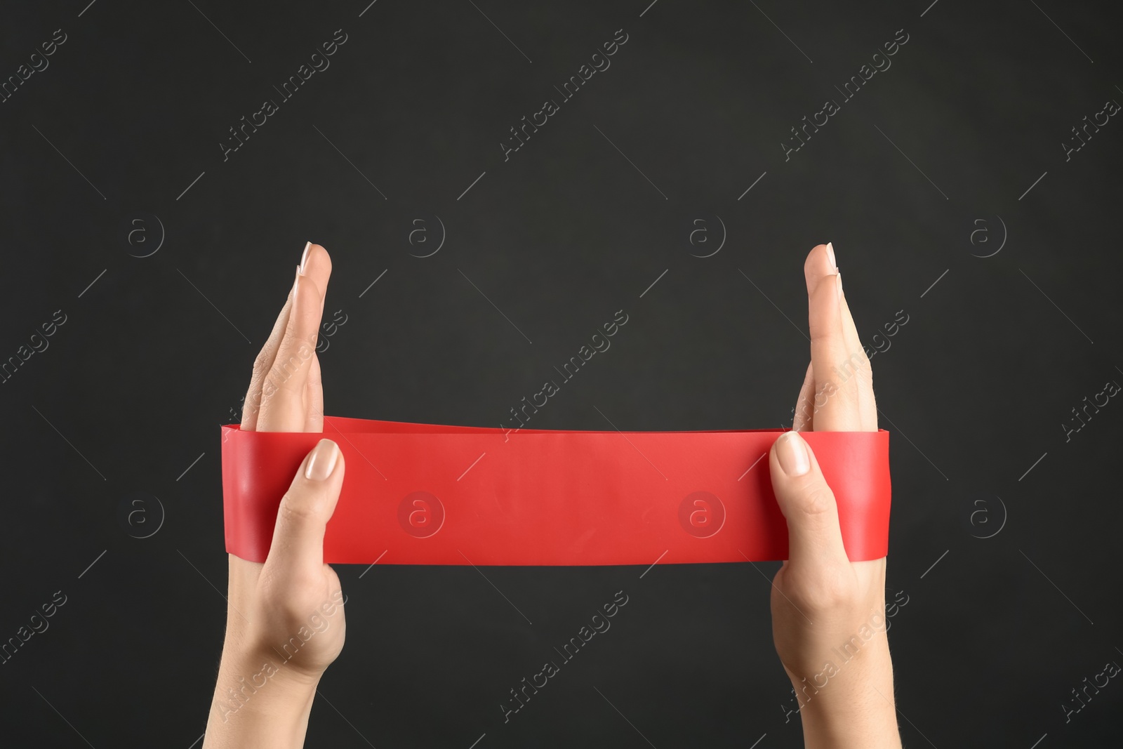 Photo of Woman with fitness elastic band on black background, closeup