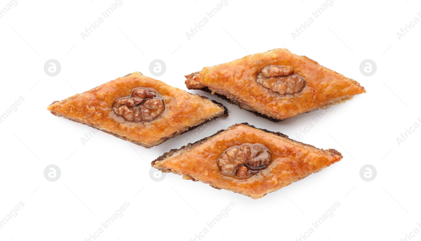 Photo of Delicious honey baklava with walnuts on white background, top view