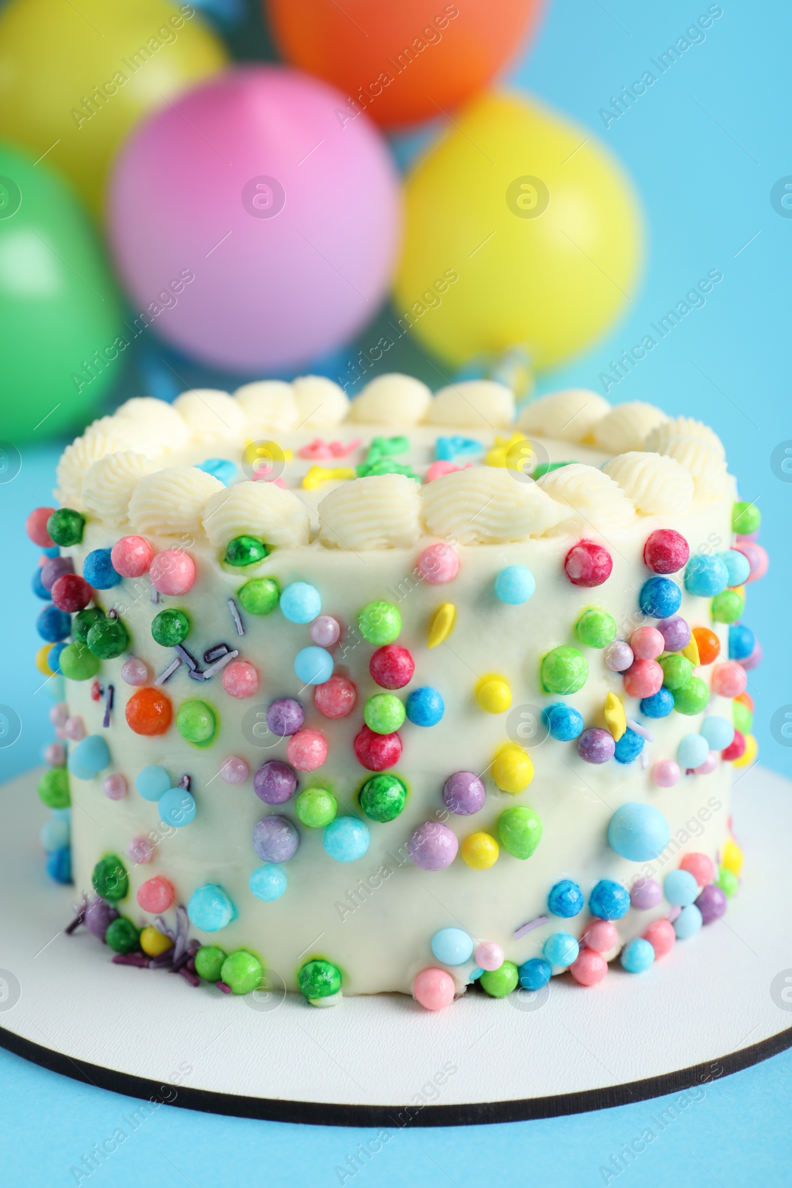 Photo of Cute bento cake with tasty cream on light blue background