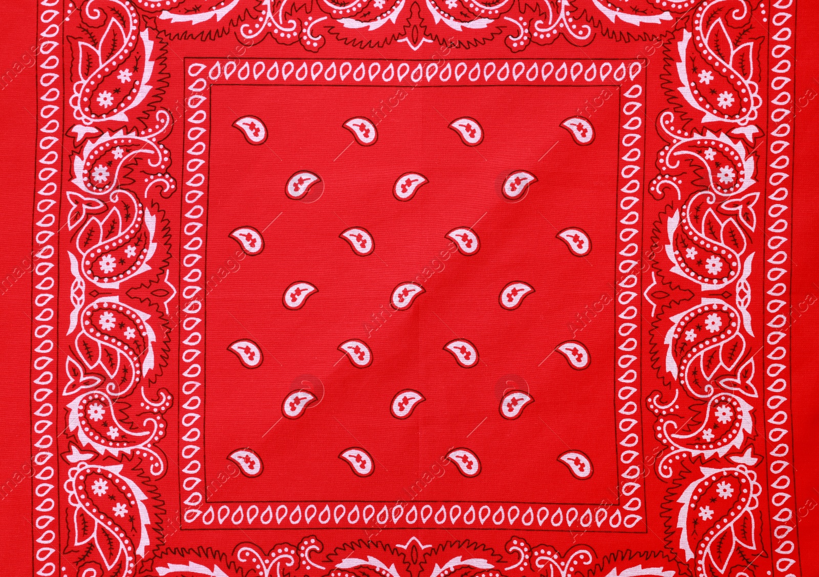 Photo of Top view of red bandana with paisley pattern as background