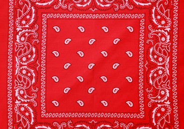 Photo of Top view of red bandana with paisley pattern as background