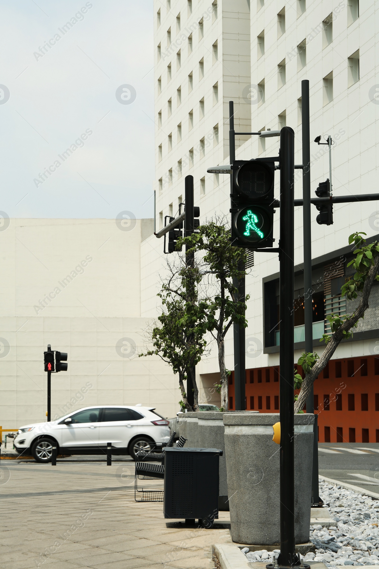 Photo of Traffic light for pedestrians on city street. Road rules