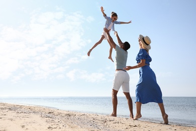 Photo of Happy family at beach on sunny summer day