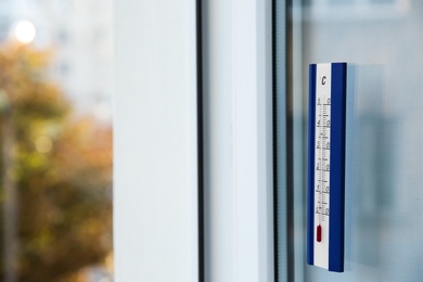 Photo of Weather thermometer on outside window. Space for text