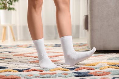 Photo of Woman in stylish white socks indoors, closeup