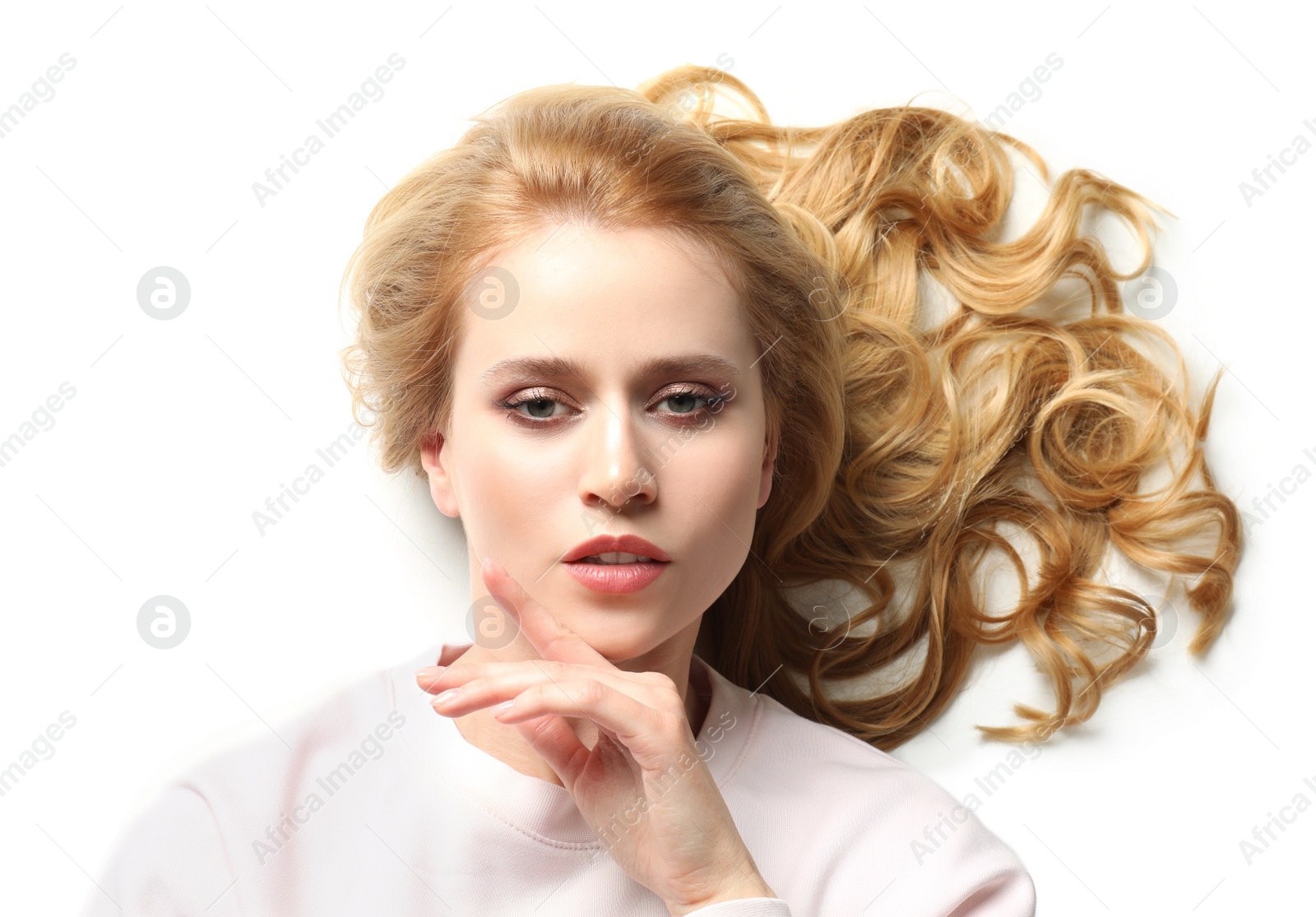 Photo of Portrait of beautiful young woman with dyed long hair on white background, top view