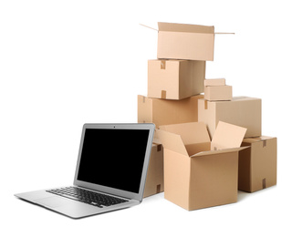 Image of Online selling. Laptop and parcels on white background