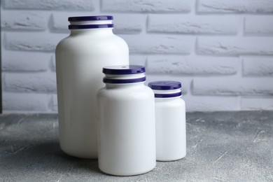 White medical bottles on light gray textured table