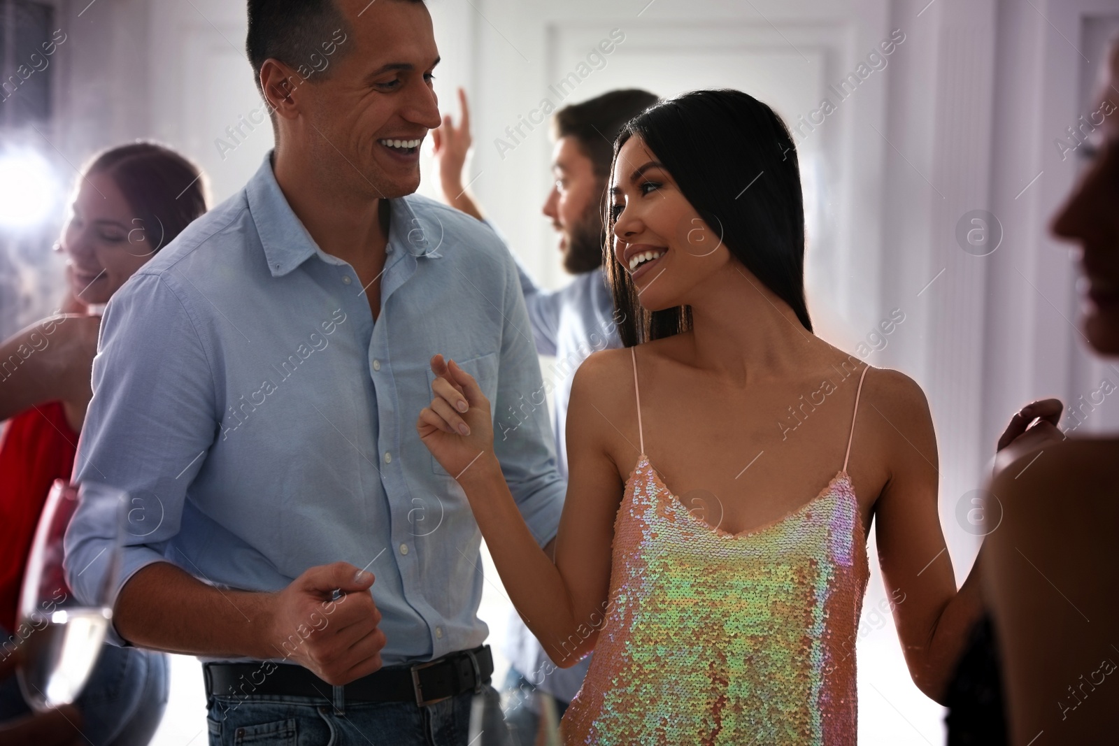 Photo of Lovely young couple dancing together at party