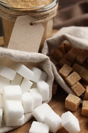 Photo of White and brown sugar on wooden table, closeup