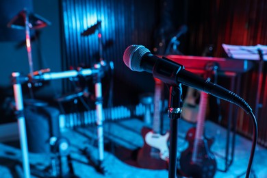 Photo of Modern microphone at recording studio, color toned. Music band practice