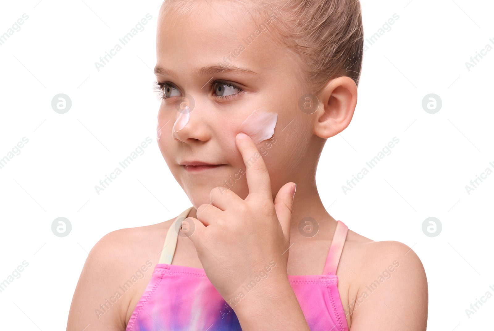 Photo of Cute girl applying sun protection cream onto her face against white background