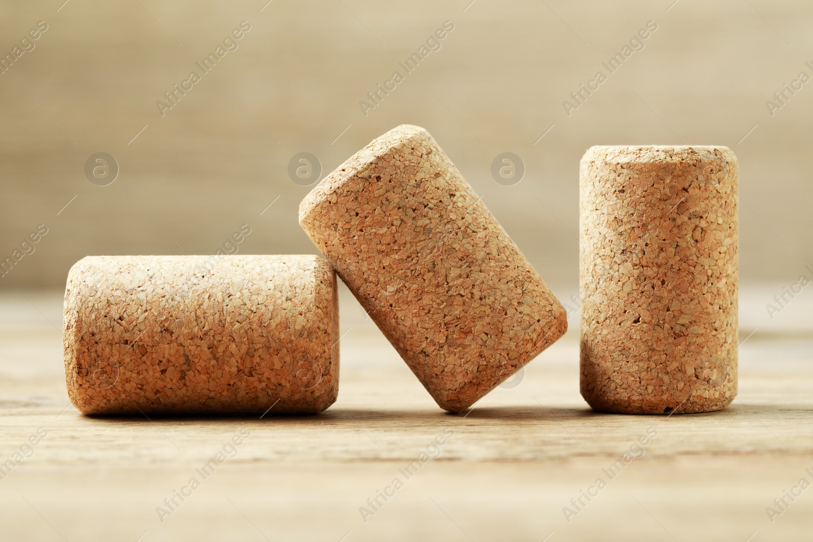 Photo of Corks of wine bottles on wooden table, closeup