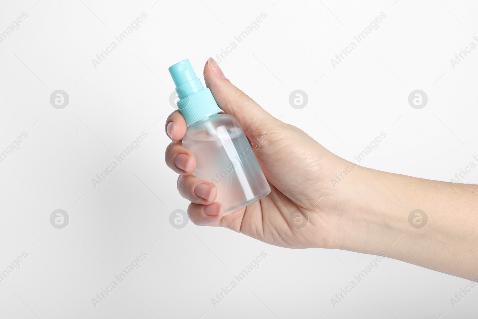 Photo of Woman holding antiseptic spray on white background, closeup