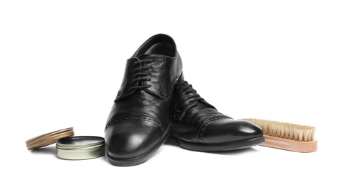 Stylish men's footwear and shoe care accessories on white background
