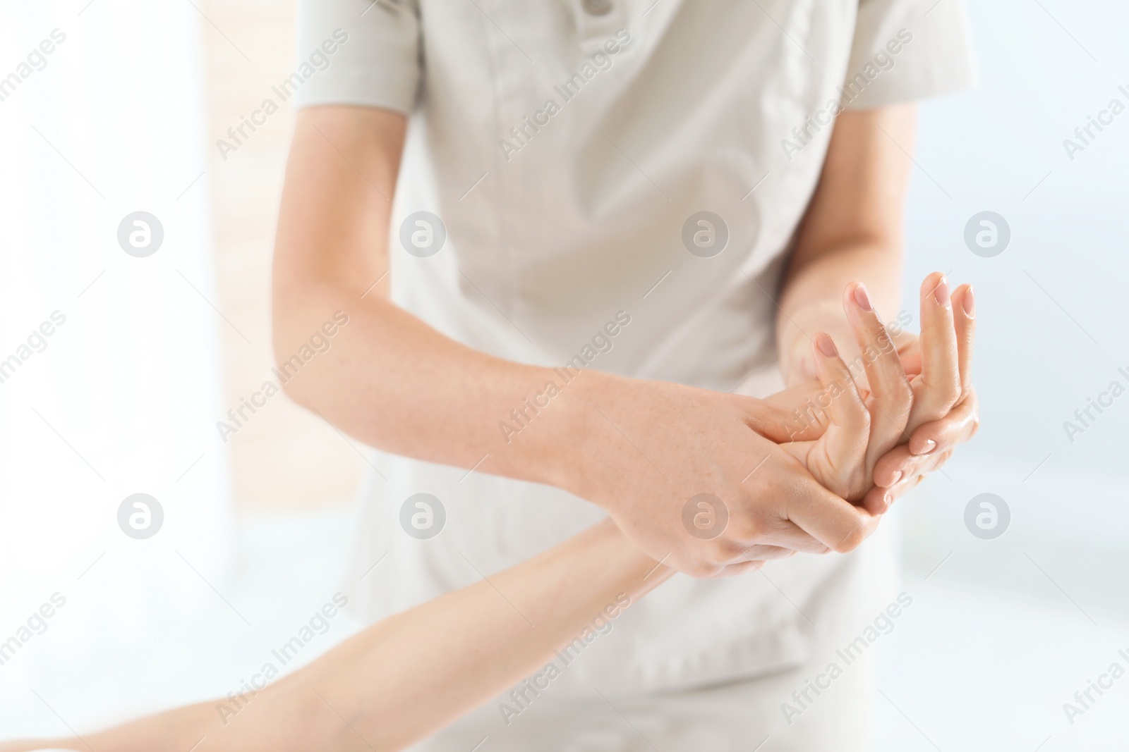 Photo of Woman receiving hand massage in wellness center, closeup