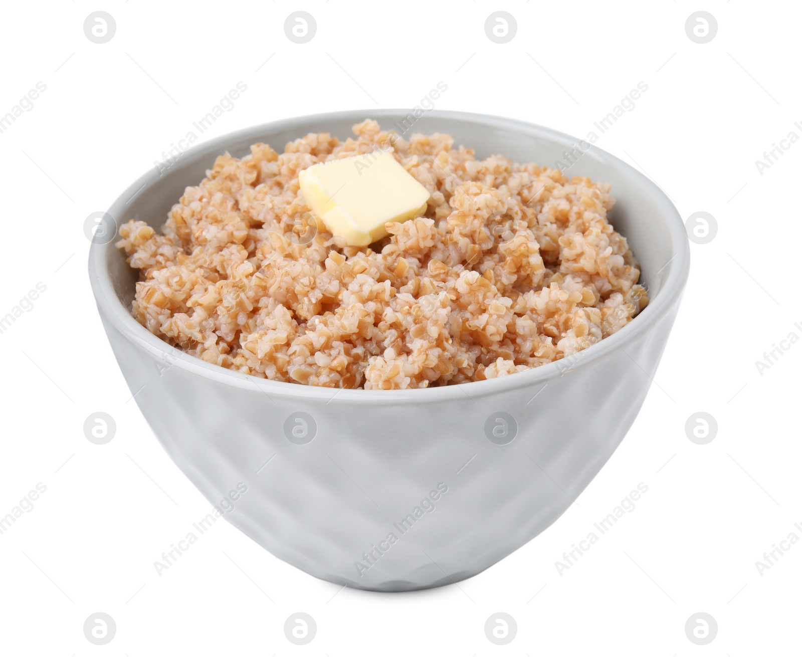 Photo of Tasty wheat porridge with butter in bowl isolated on white