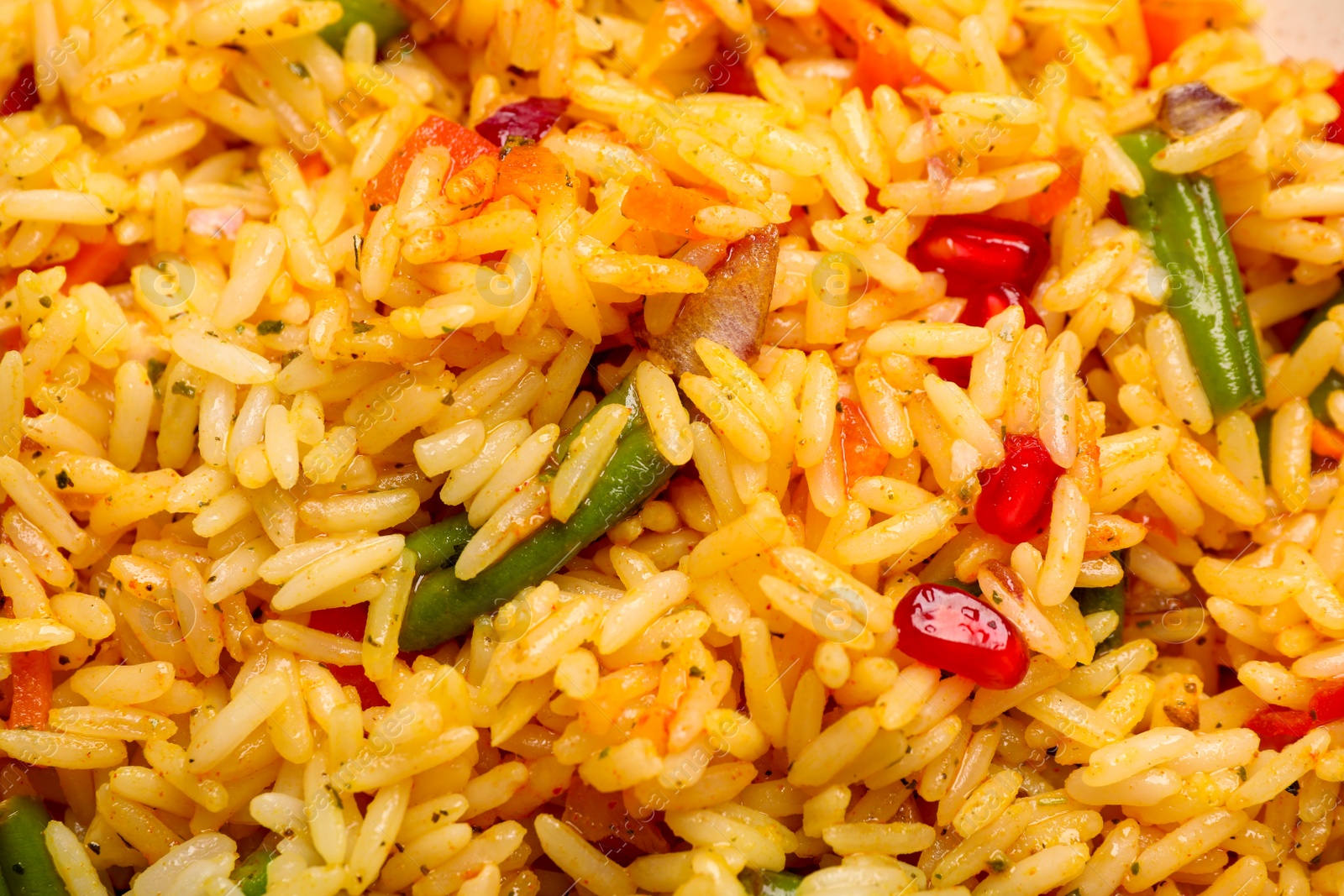 Photo of Tasty rice pilaf with vegetables as background, closeup