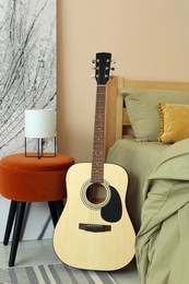 Photo of Stylish teenager's room interior with comfortable bed and guitar