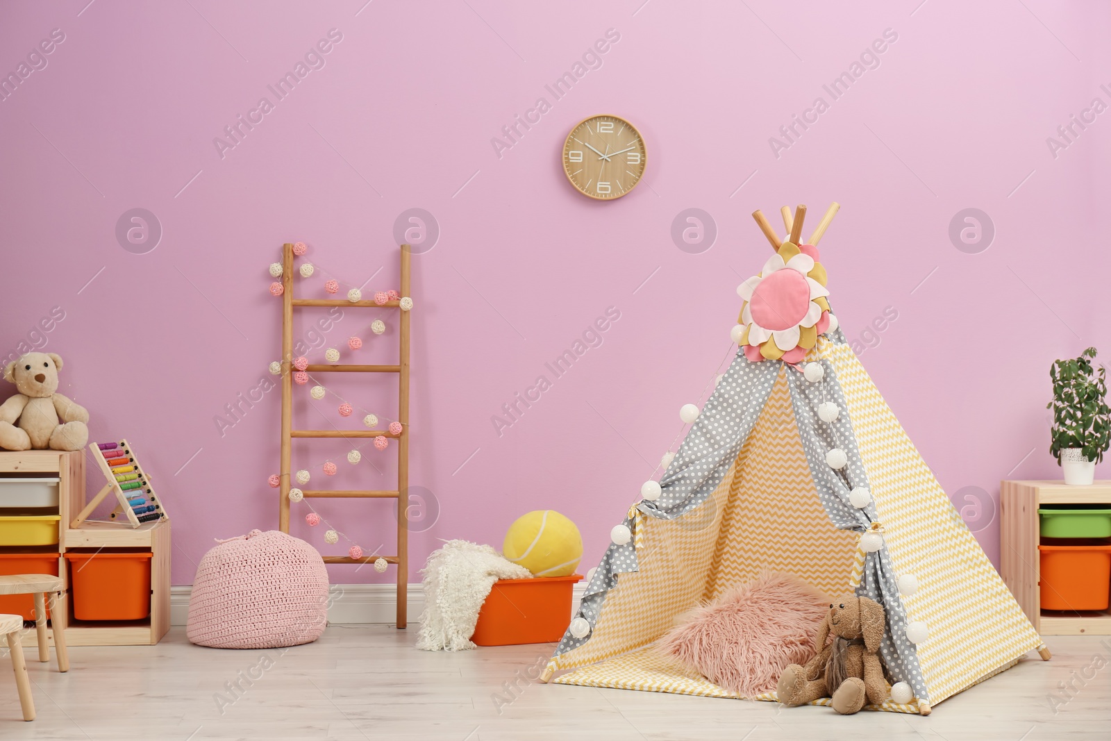 Photo of Modern nursery room interior with play tent for kids