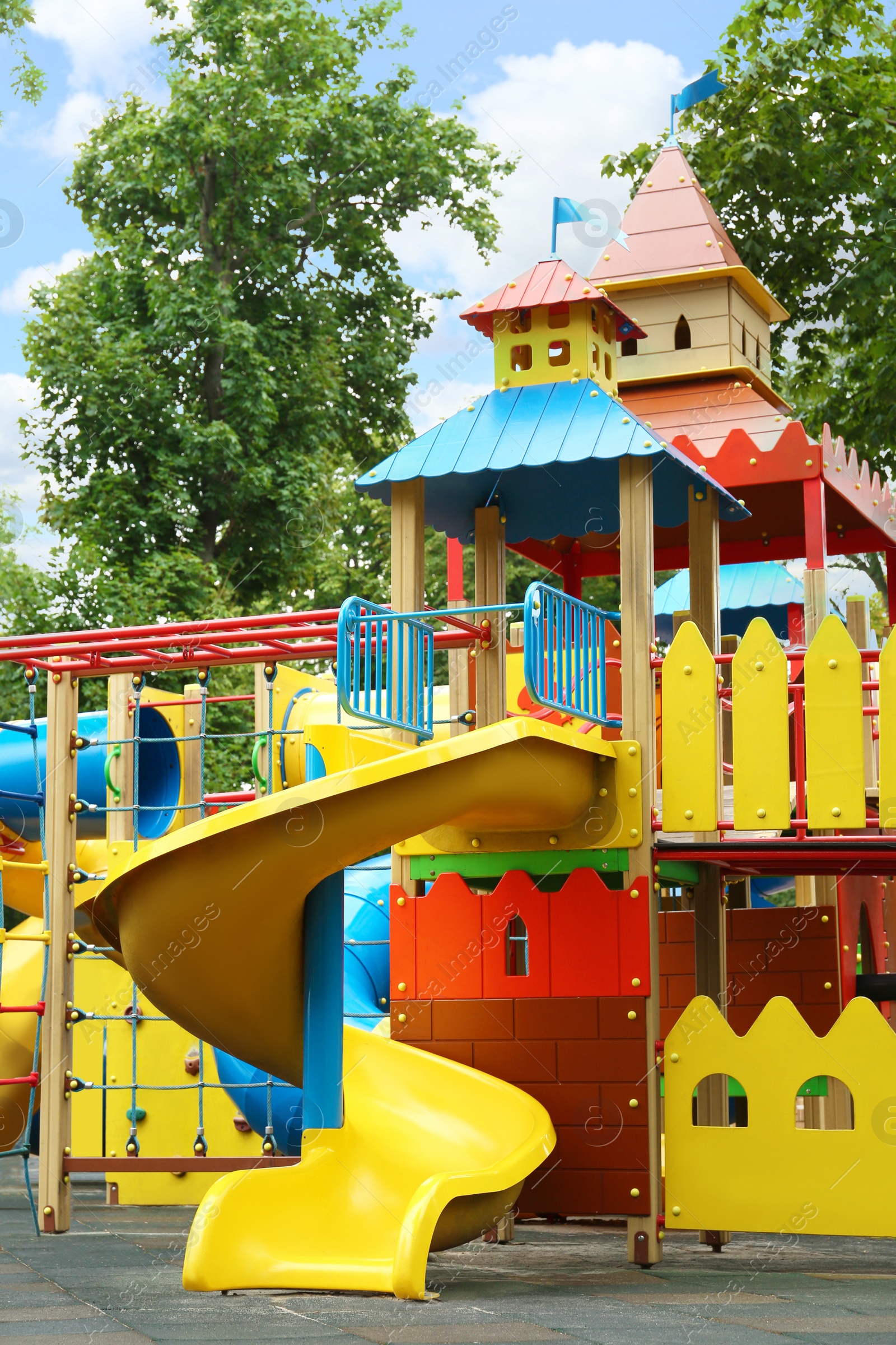 Photo of New colorful castle playhouse with slide on children's playground