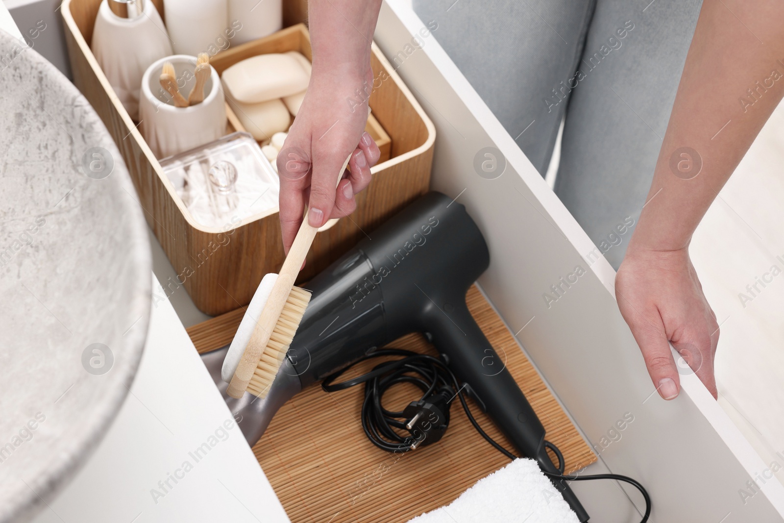 Photo of Bath accessories. Woman organizing personal care products indoors, closeup