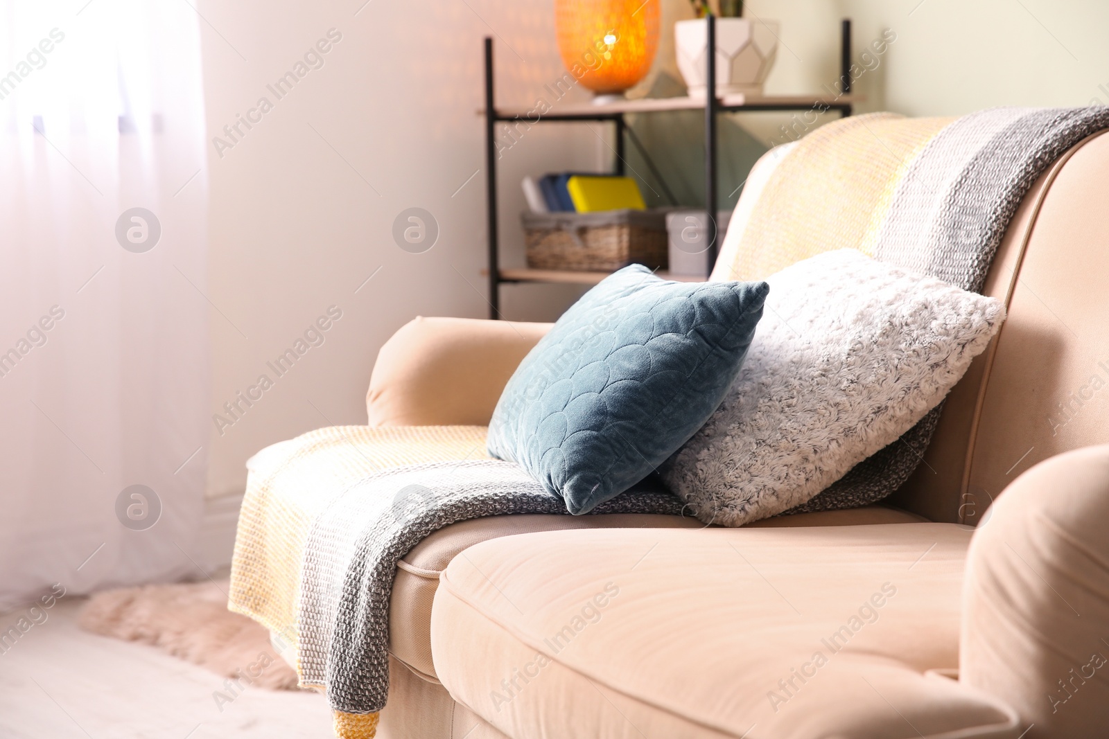 Photo of Comfortable sofa with soft pillows in living room