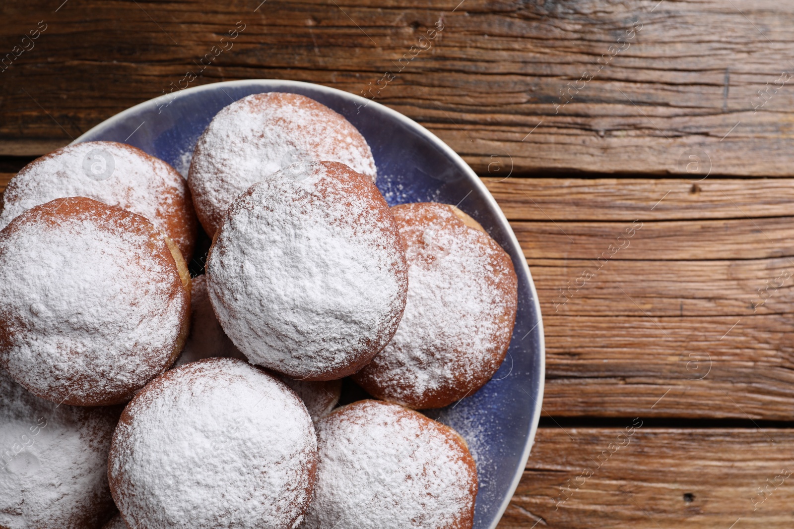 Photo of Delicious sweet buns on wooden table, top view. Space for text