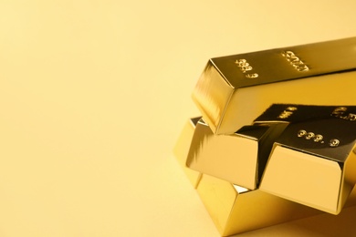 Photo of Shiny gold bars on color background. Space for text