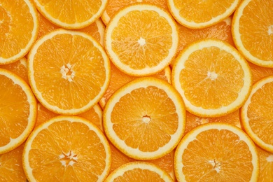 Photo of Fresh orange slices as background, top view